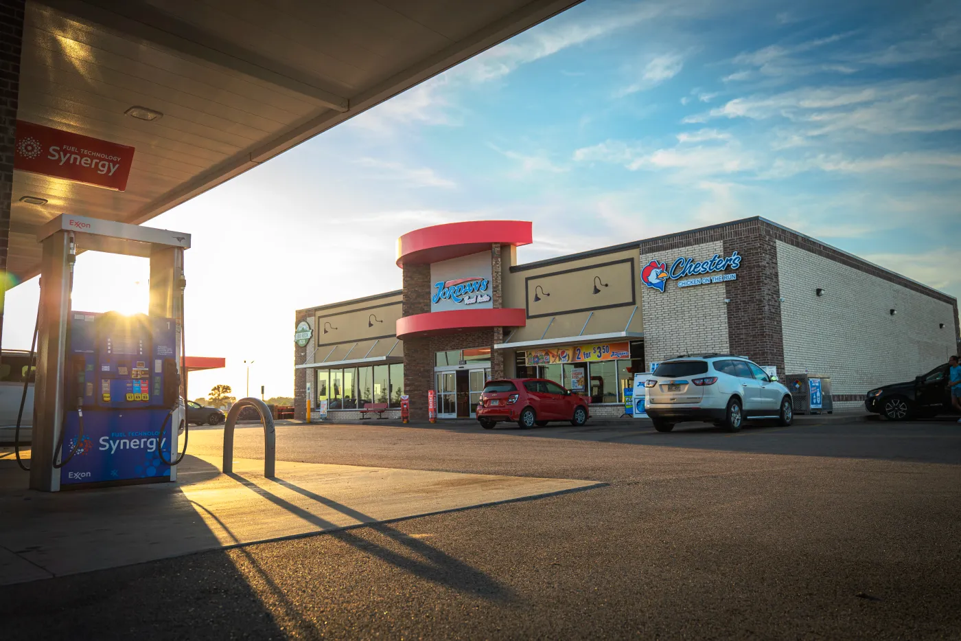 A Jordan's Kwik Stop forecourt and storefront at sunrise