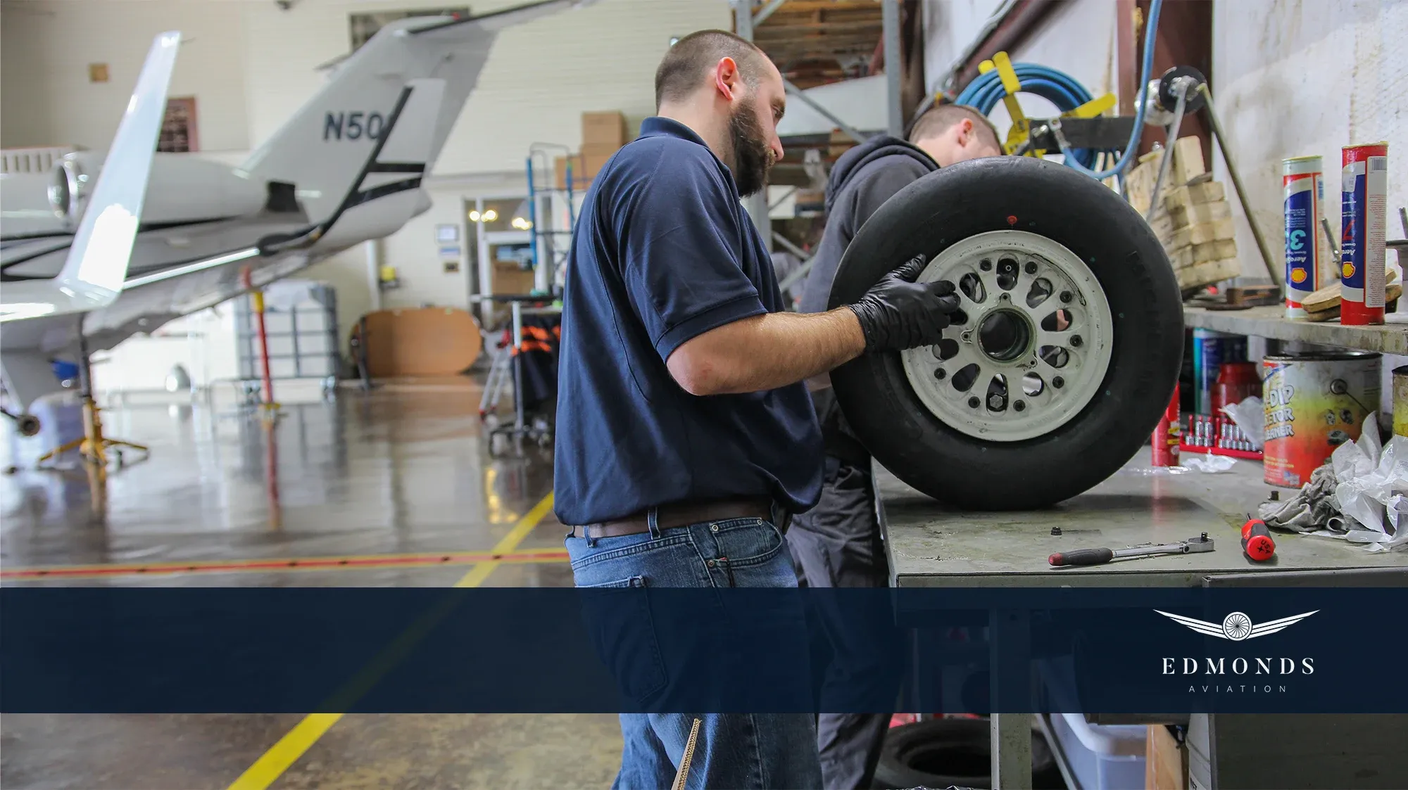 A technician servicing a landing gear assembly