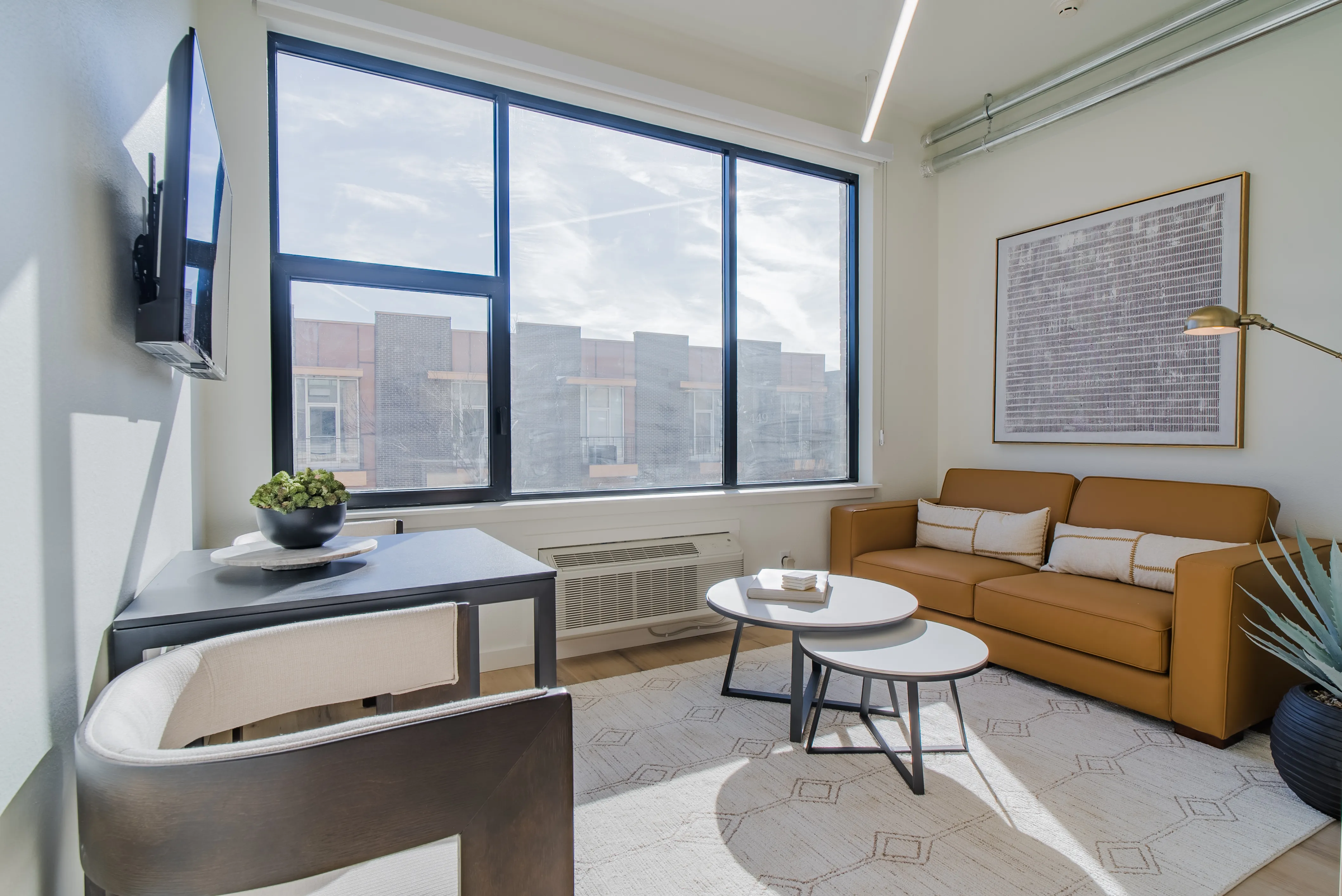 A light-filled apartment kitchen and living area at The Urban Loft Co.